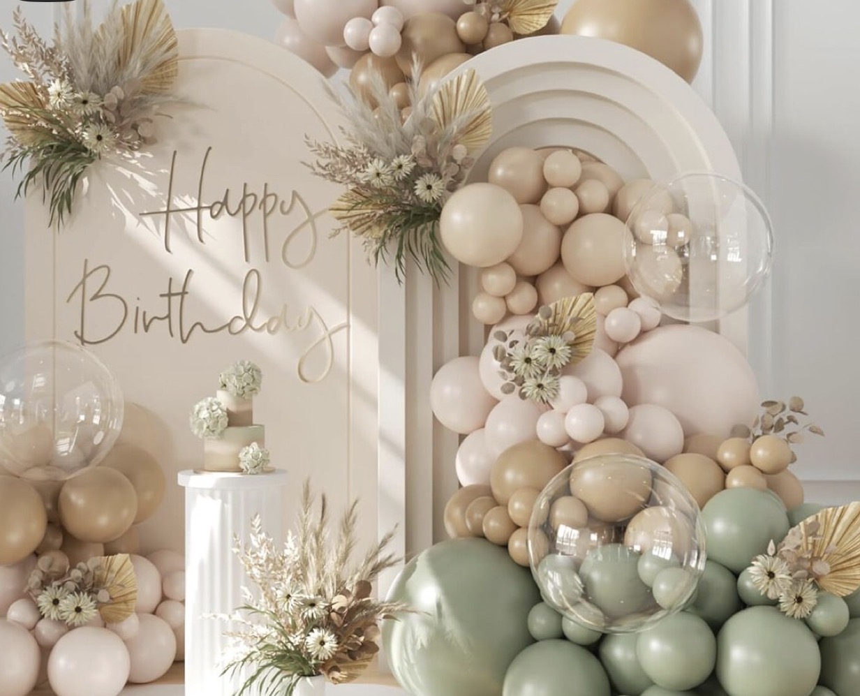 Neutral birthday backdrop with balloon garland