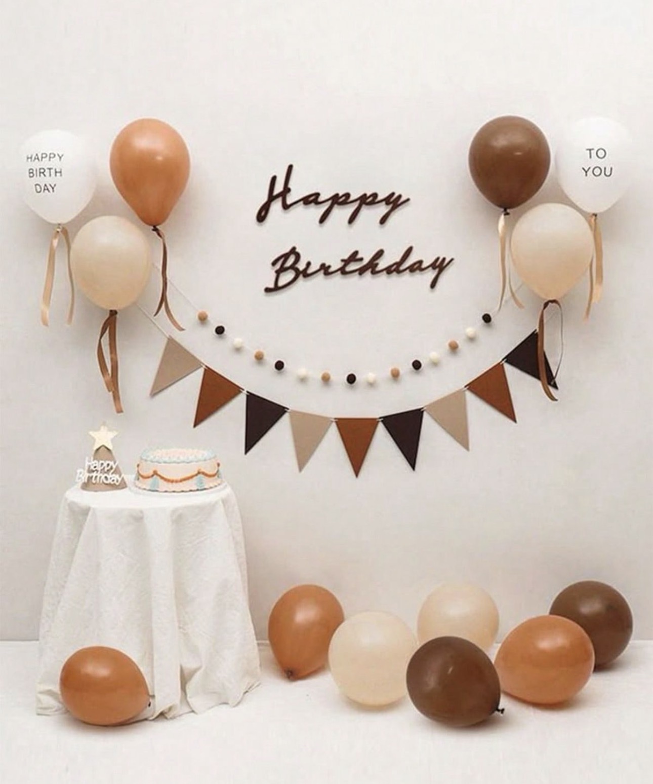 Brown and cream birthday backdrop with balloons