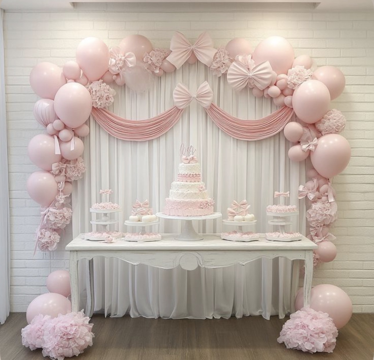 Pink bow dessert table with balloon arch