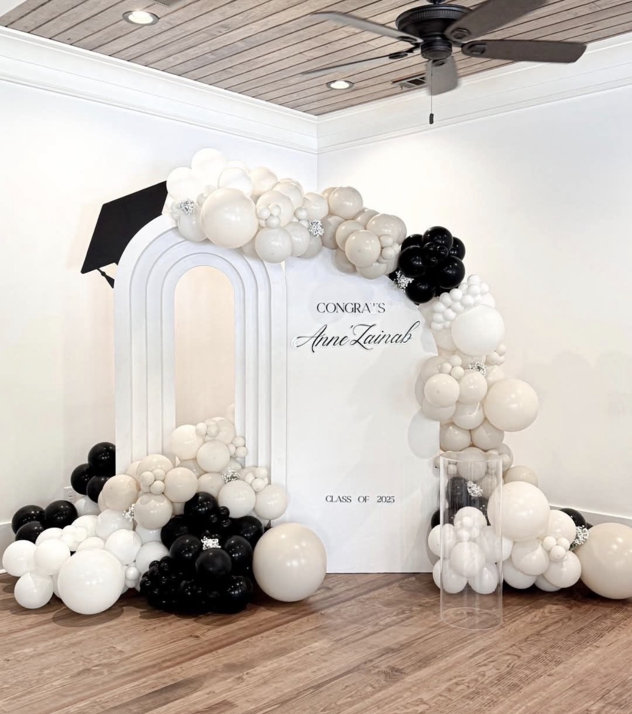 Indoor graduation backdrop with neutral and black balloons