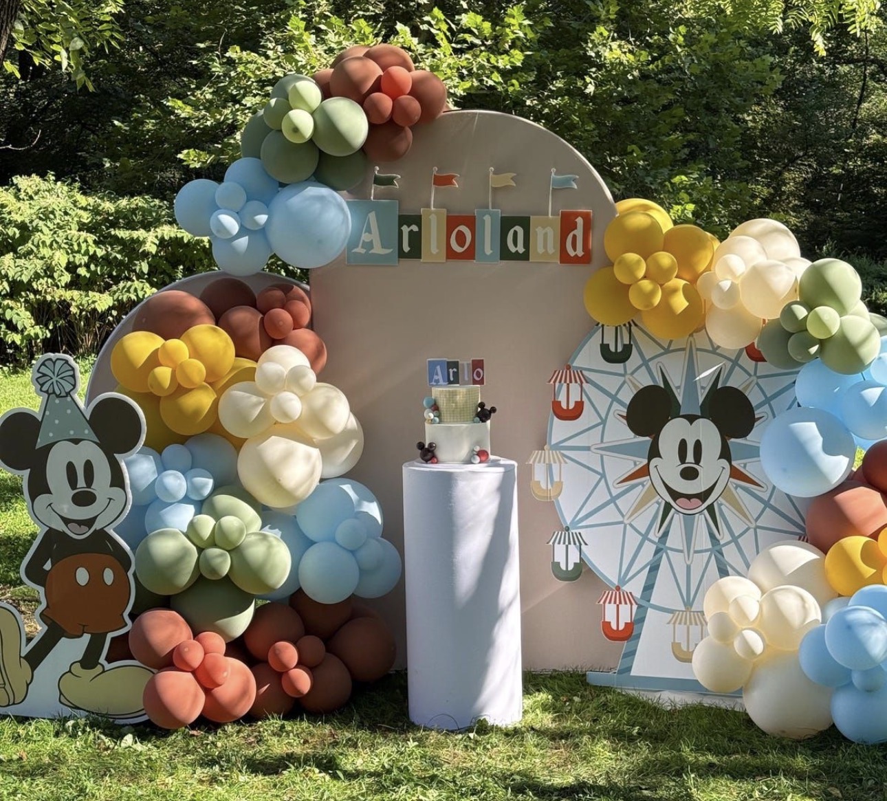 Colorful outdoor birthday backdrop with balloon styling