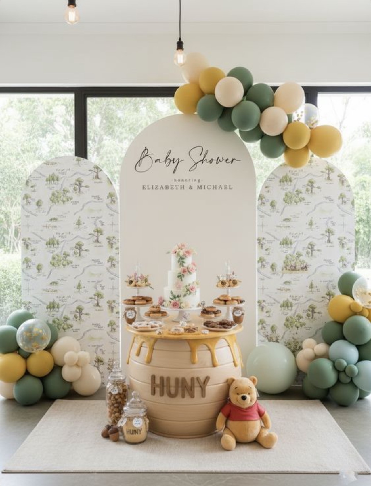 Baby shower backdrop with green and gold balloons